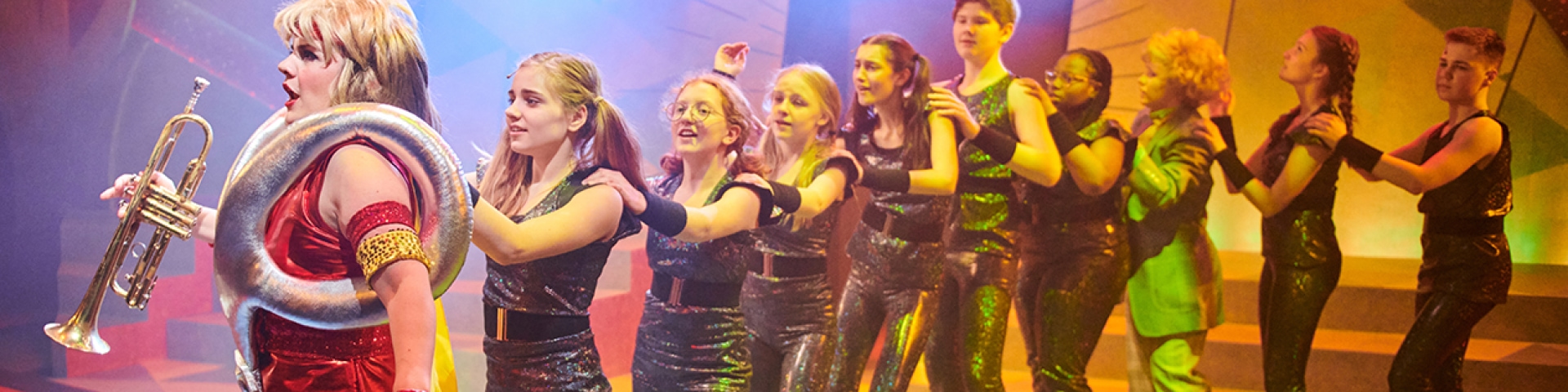 a group of girls dancing on a stage